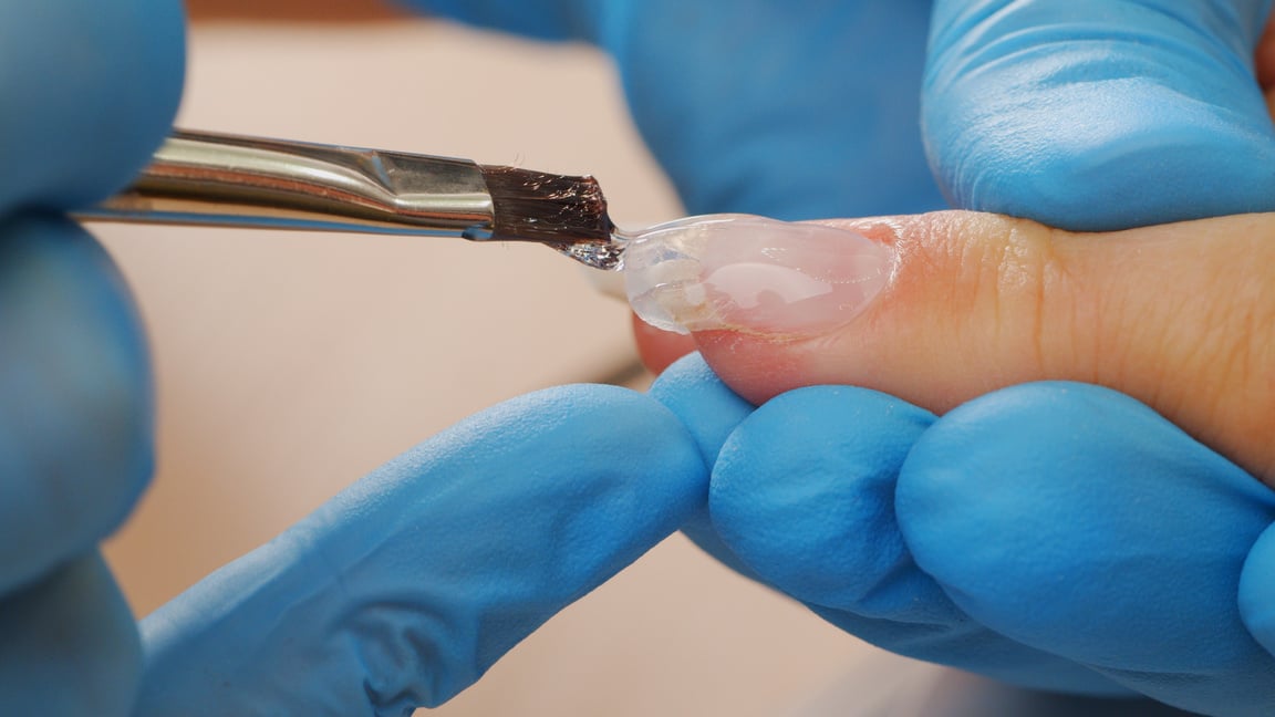 Manicurist Paints Nails with  Gel Polish. Application of Acrylic